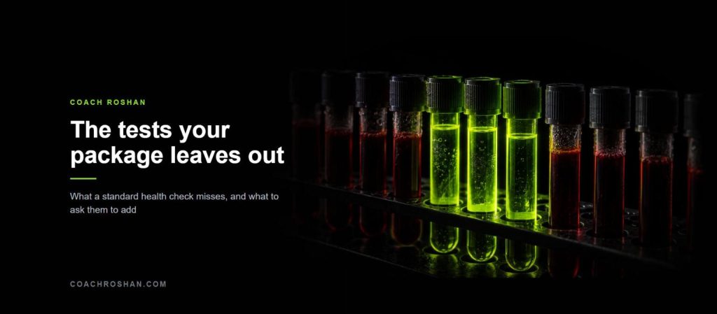 A rack of blood collection tubes with three glowing lime green among dim red ones, illustrating the tests a standard health package leaves out